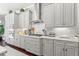 Modern kitchen with gray cabinets, stainless steel appliances, and granite countertops at 8414 Dunham Station Dr, Tampa, FL 33647