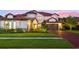 Two-story house with a brick driveway and a beautifully landscaped lawn at 8414 Dunham Station Dr, Tampa, FL 33647