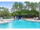 Community pool with waterslide and lounge chairs at 8414 Dunham Station Dr, Tampa, FL 33647