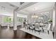 Formal dining room with large chandelier and seating for eight at 8414 Dunham Station Dr, Tampa, FL 33647