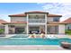 Luxury backyard oasis featuring a large pool, spa, and spacious patio at 8414 Dunham Station Dr, Tampa, FL 33647
