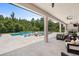 Covered patio overlooks the pool and features comfortable seating at 8414 Dunham Station Dr, Tampa, FL 33647