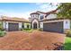 Two-story home with a three-car garage and brick driveway at 8414 Dunham Station Dr, Tampa, FL 33647