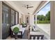 Relaxing covered patio with comfortable seating and outdoor fans at 8414 Dunham Station Dr, Tampa, FL 33647