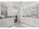 Double vanity bathroom with gray countertops and white cabinets at 8414 Dunham Station Dr, Tampa, FL 33647