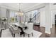 Open concept dining room with modern chandelier and seating for eight at 8414 Dunham Station Dr, Tampa, FL 33647