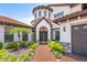 Elegant home entrance with brick walkway and lush landscaping at 8414 Dunham Station Dr, Tampa, FL 33647