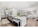 Open concept kitchen with large island and a view into living area at 8414 Dunham Station Dr, Tampa, FL 33647