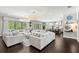 Open living room showcasing ample seating and a seamless transition to the kitchen at 8414 Dunham Station Dr, Tampa, FL 33647
