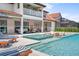 Resort-style pool and spa with outdoor seating and covered patio at 8414 Dunham Station Dr, Tampa, FL 33647