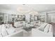 Spacious living room with white sofas and large windows at 8414 Dunham Station Dr, Tampa, FL 33647