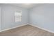 Light blue bedroom with wood-look flooring and a window with blinds at 7779 Yale Harbor Dr, Wesley Chapel, FL 33545