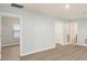 Spacious living room with light walls and wood floors at 7779 Yale Harbor Dr, Wesley Chapel, FL 33545