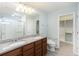 Double vanity bathroom with granite countertops and a walk-in shower at 7779 Yale Harbor Dr, Wesley Chapel, FL 33545