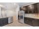 Modern kitchen with dark brown cabinets and stainless steel appliances at 7779 Yale Harbor Dr, Wesley Chapel, FL 33545