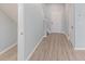 Inviting entryway with wood-look floors and staircase at 7779 Yale Harbor Dr, Wesley Chapel, FL 33545