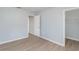 Bedroom with wood-look floors, a closet, and an adjoining bathroom at 7779 Yale Harbor Dr, Wesley Chapel, FL 33545