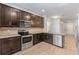 Modern kitchen with dark cabinetry and granite countertops at 7779 Yale Harbor Dr, Wesley Chapel, FL 33545