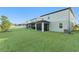 Spacious backyard with green lawn and home's exterior visible at 7779 Yale Harbor Dr, Wesley Chapel, FL 33545