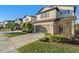 Two-story house with neutral siding, brown garage door, and manicured landscaping at 7779 Yale Harbor Dr, Wesley Chapel, FL 33545