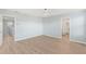Bright bedroom with light walls, wood-look flooring, and ceiling fan at 7779 Yale Harbor Dr, Wesley Chapel, FL 33545