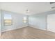 Spacious bedroom with light walls, wood-look flooring, and large windows at 7779 Yale Harbor Dr, Wesley Chapel, FL 33545