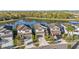 Aerial view of five houses near a lake, showcasing a desirable community setting at 7779 Yale Harbor Dr, Wesley Chapel, FL 33545
