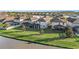 Aerial view showcasing lakefront homes and lush landscaping at 7779 Yale Harbor Dr, Wesley Chapel, FL 33545