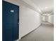 Apartment hallway with blue door and carpeting at 3315 58Th S Ave # 309, St Petersburg, FL 33712
