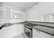 Modern kitchen featuring white cabinets, gray countertops, and stainless steel appliances at 3315 58Th S Ave # 309, St Petersburg, FL 33712