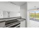 Kitchen with stainless steel appliances and view to a sliding glass door leading to a balcony at 3315 58Th S Ave # 309, St Petersburg, FL 33712