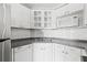 Well-equipped kitchen with white cabinets and grey countertops at 3315 58Th S Ave # 309, St Petersburg, FL 33712