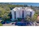 Aerial view of building with parking and waterfront views at 2699 Seville Blvd # 303, Clearwater, FL 33764