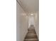 Long hallway with wood-look floors and built-in storage at 2699 Seville Blvd # 303, Clearwater, FL 33764
