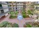 Lovely courtyard with fountain and tropical landscaping at 2699 Seville Blvd # 303, Clearwater, FL 33764