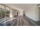 Bright and airy living room with hardwood-style flooring at 2699 Seville Blvd # 303, Clearwater, FL 33764