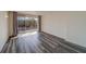Bedroom with wood-look floors and sliding doors to balcony at 2699 Seville Blvd # 303, Clearwater, FL 33764