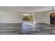 Living room with hardwood-style flooring and sliding doors to balcony at 2699 Seville Blvd # 303, Clearwater, FL 33764