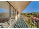 Spacious balcony with green tiled floor and metal railing at 2699 Seville Blvd # 303, Clearwater, FL 33764