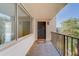 Bright condo entryway with private balcony, featuring a black door and large windows at 2699 Seville Blvd # 303, Clearwater, FL 33764