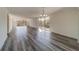 Open living room featuring wood-look floors and a chandelier at 2699 Seville Blvd # 303, Clearwater, FL 33764