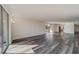 Sunlit living area with hardwood-style flooring and access to balcony at 2699 Seville Blvd # 303, Clearwater, FL 33764