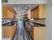 Bright kitchen features granite countertops and modern appliances at 2699 Seville Blvd # 303, Clearwater, FL 33764