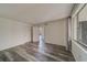 Spacious bedroom with wood-look floors and access to a private balcony at 2699 Seville Blvd # 303, Clearwater, FL 33764