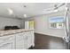 Modern kitchen island with granite countertops, white cabinets and dark hardwood floors at 345 S Mcmullen Booth Rd # 142, Clearwater, FL 33759