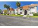 Side view of a condo building showcasing its light-colored facade and landscaping at 345 S Mcmullen Booth Rd # 142, Clearwater, FL 33759