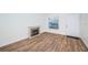 Living room with wood-look floors and electric fireplace at 3455 Countryside Blvd # 52, Clearwater, FL 33761