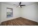 Well-lit bedroom with wood-look floors and a window with view at 3455 Countryside Blvd # 52, Clearwater, FL 33761