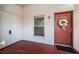 Condo entrance with red door and wreath at 3455 Countryside Blvd # 52, Clearwater, FL 33761
