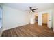 Bright bedroom with wood-look floors and ceiling fan at 3455 Countryside Blvd # 52, Clearwater, FL 33761